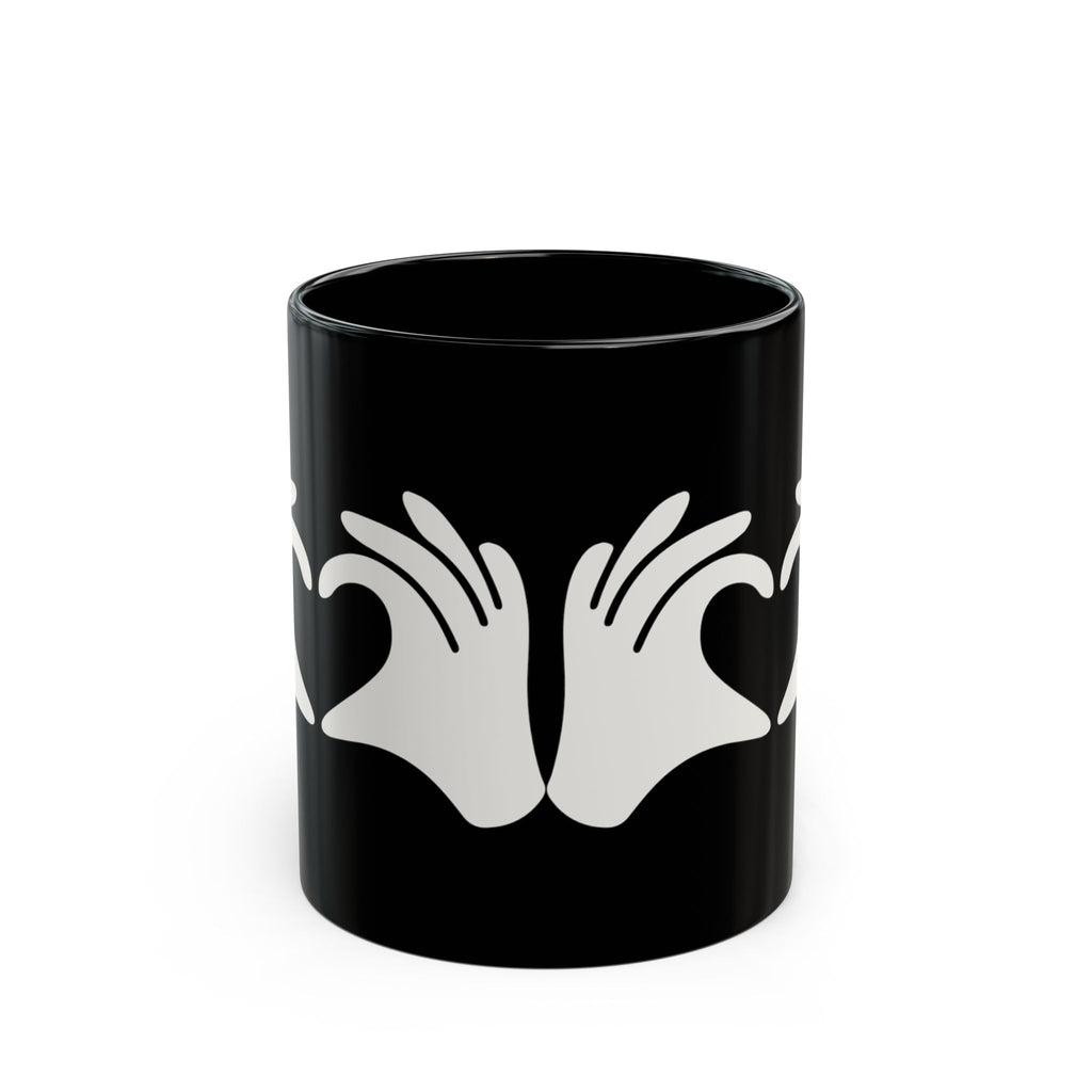 Black mug with white hand design on a white background