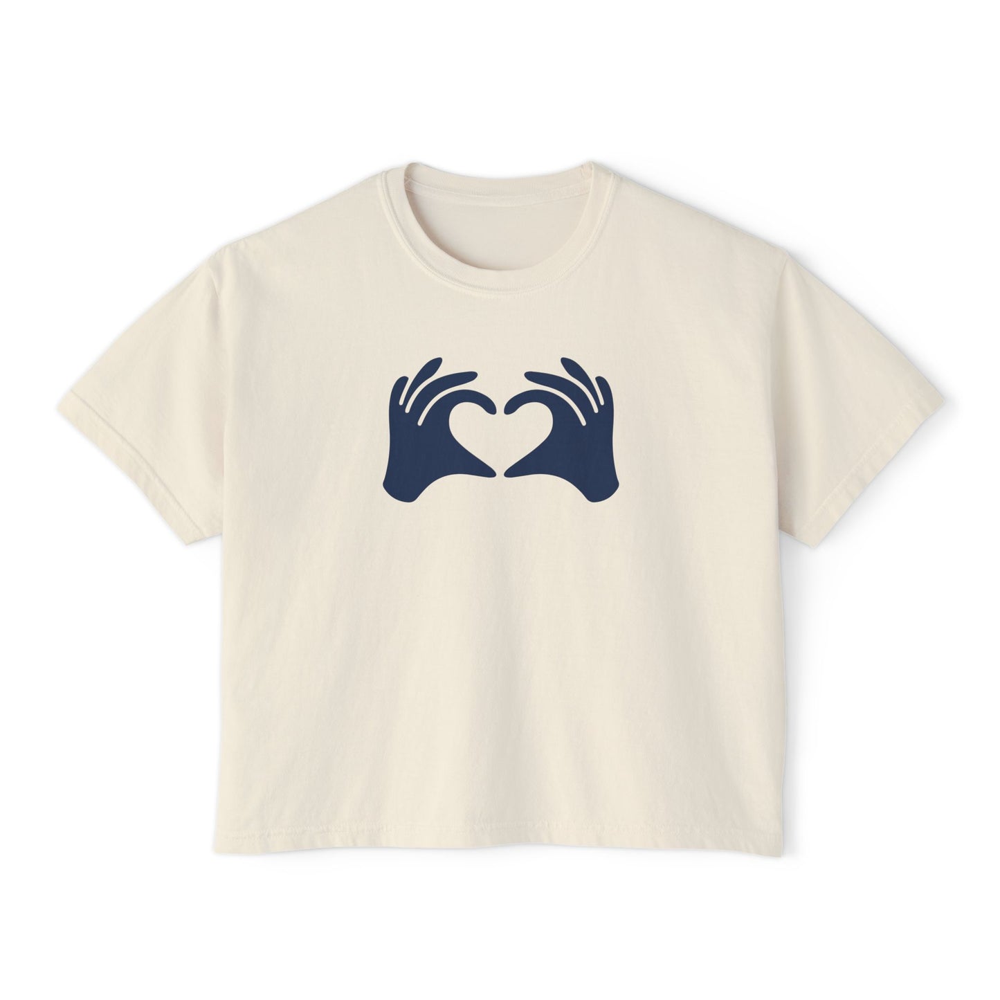 Beige t-shirt with navy blue graphic of hands forming a heart on a white background