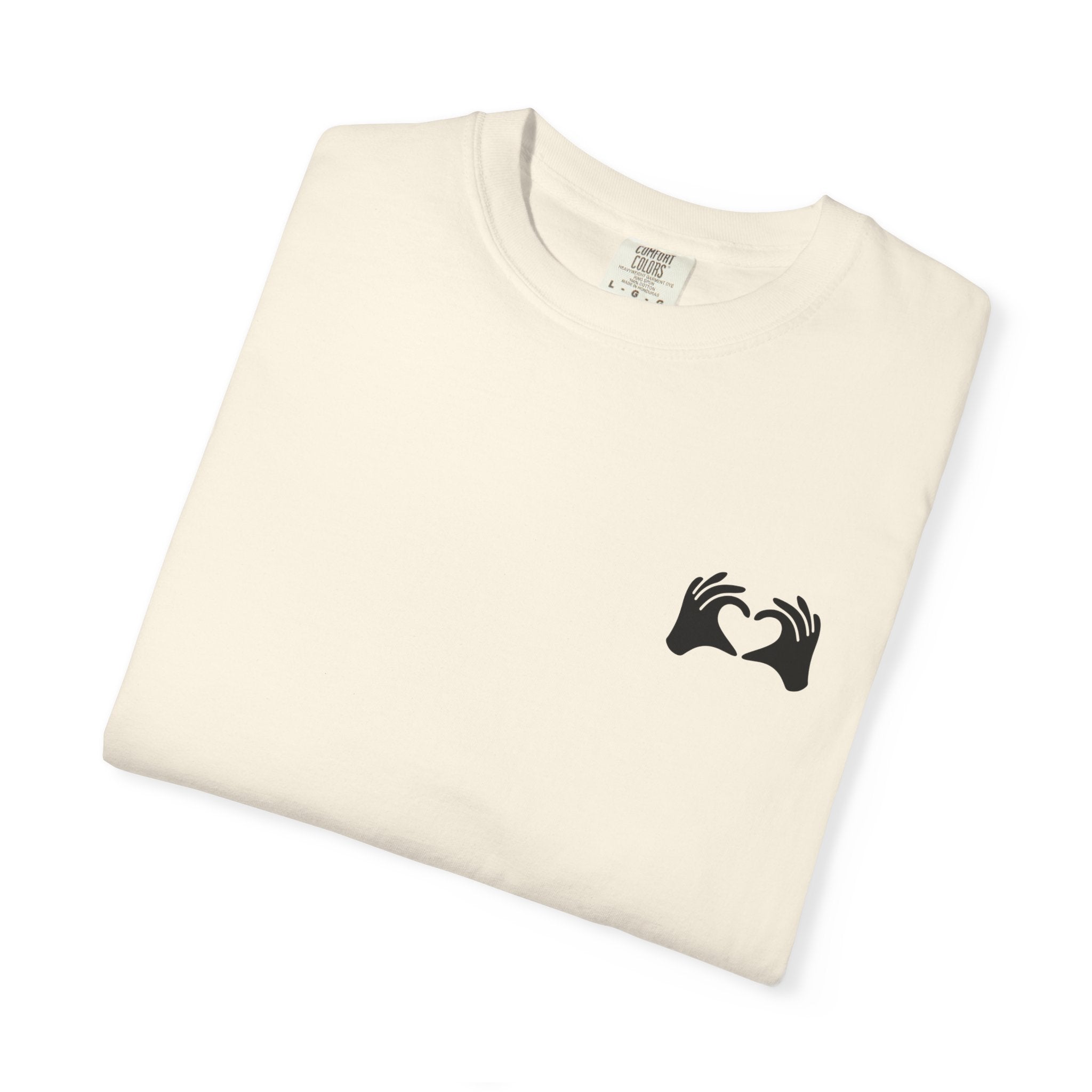 Folded cream-colored t-shirt with a colorful graphic on a white background
