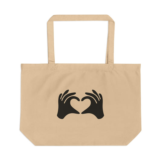 Beige tote bag with black hand heart design on a white background