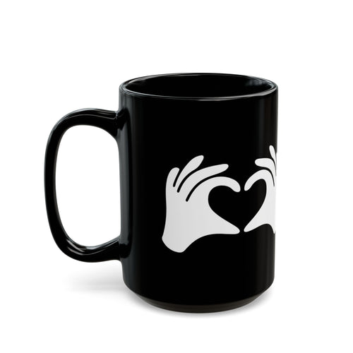 Black mug with white hand icon forming a heart on a white background
