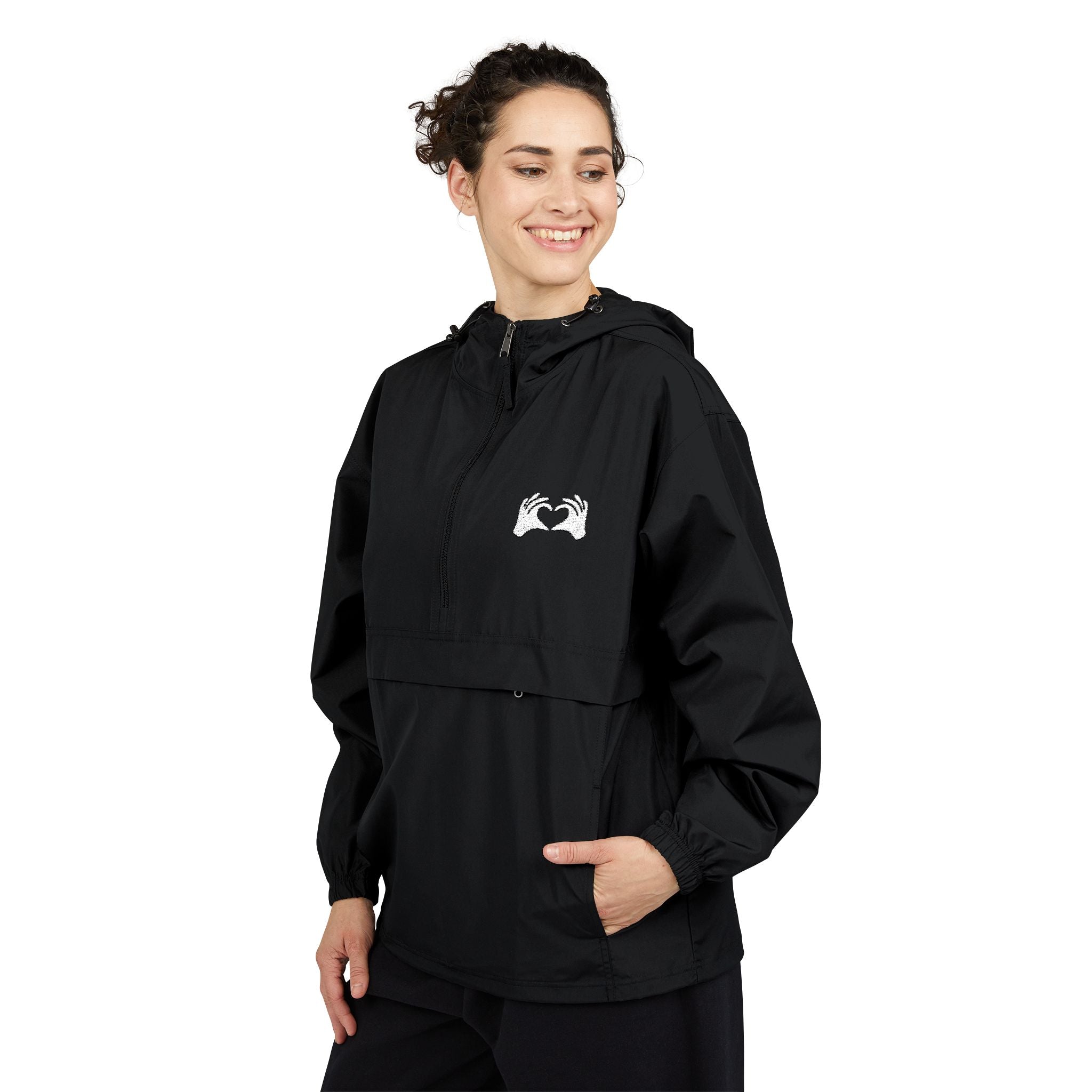 Person wearing a black hooded jacket with a logo on a white background