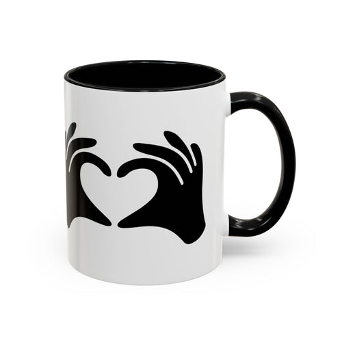 White mug with black handle and black heart design on a white background