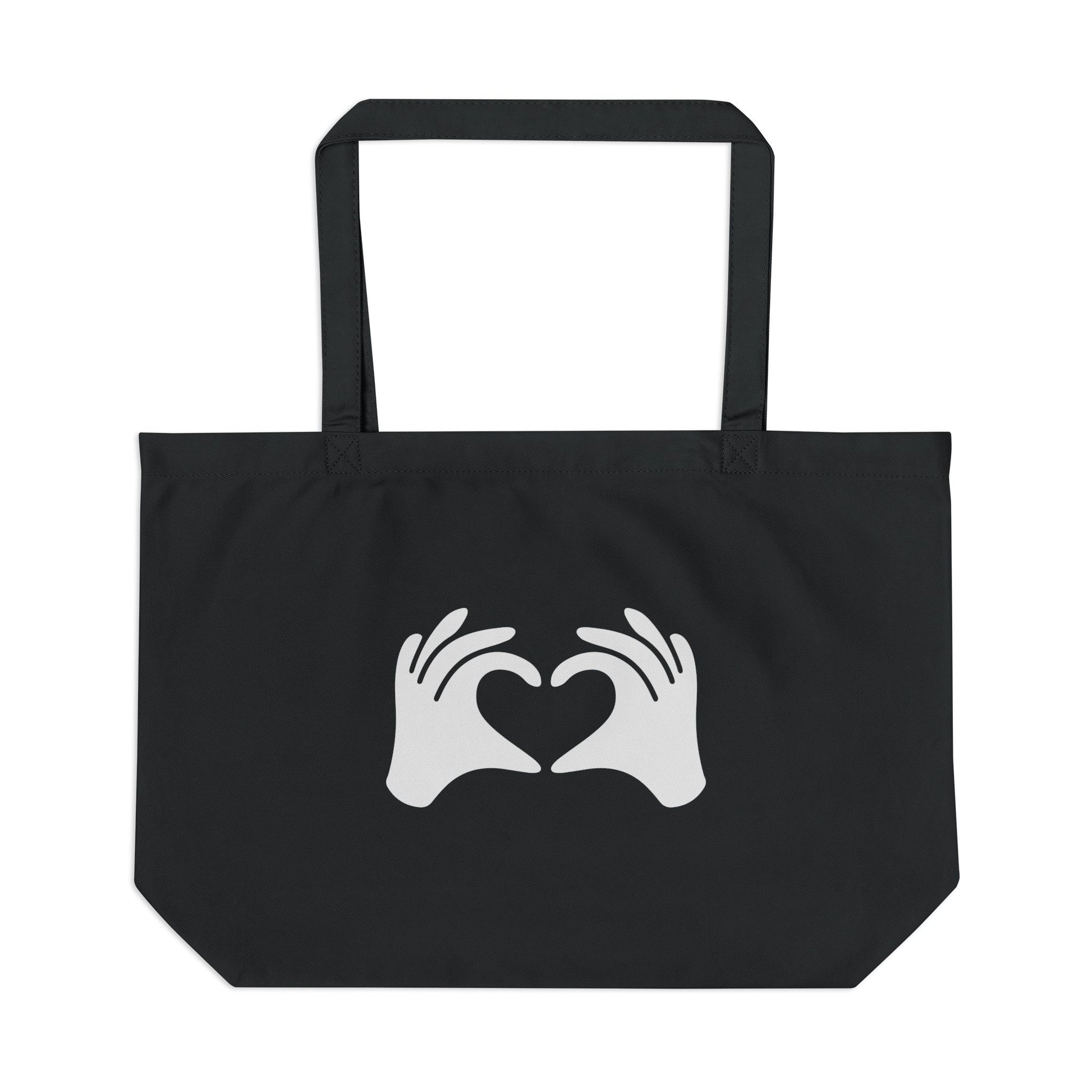 Black tote bag with white hands forming a heart design on a white background