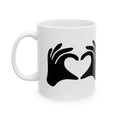 White mug with black hand-shaped heart design on a white background