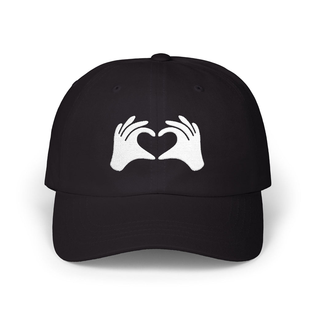 Black cap with white hands forming a heart design on a white background