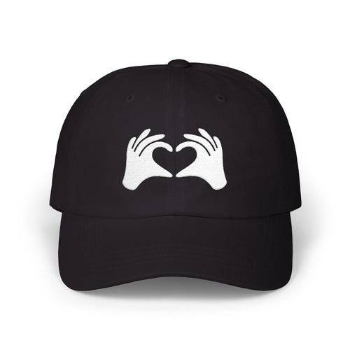 Black cap with white hands forming a heart design on a white background