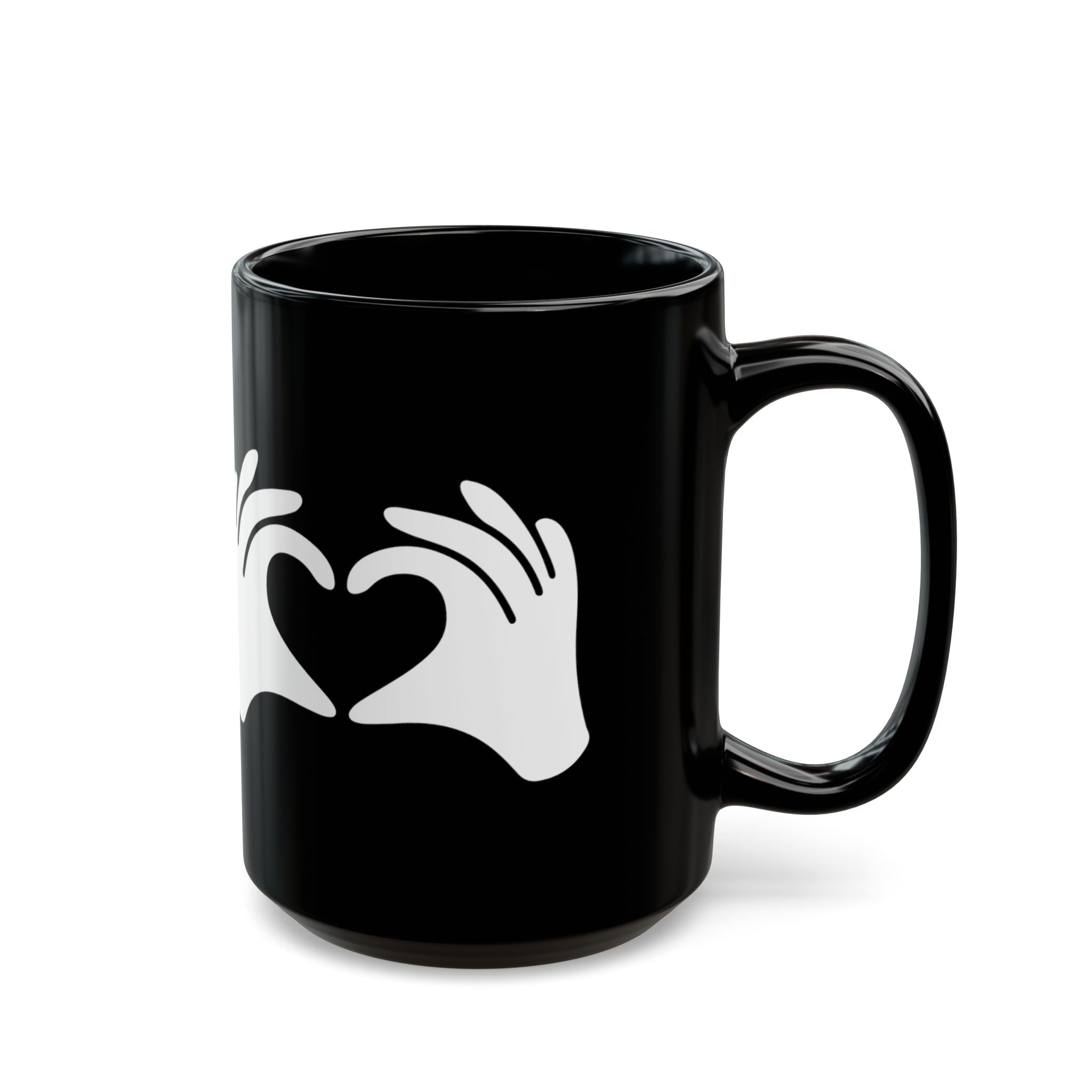Black mug with white hand and heart design on a white background