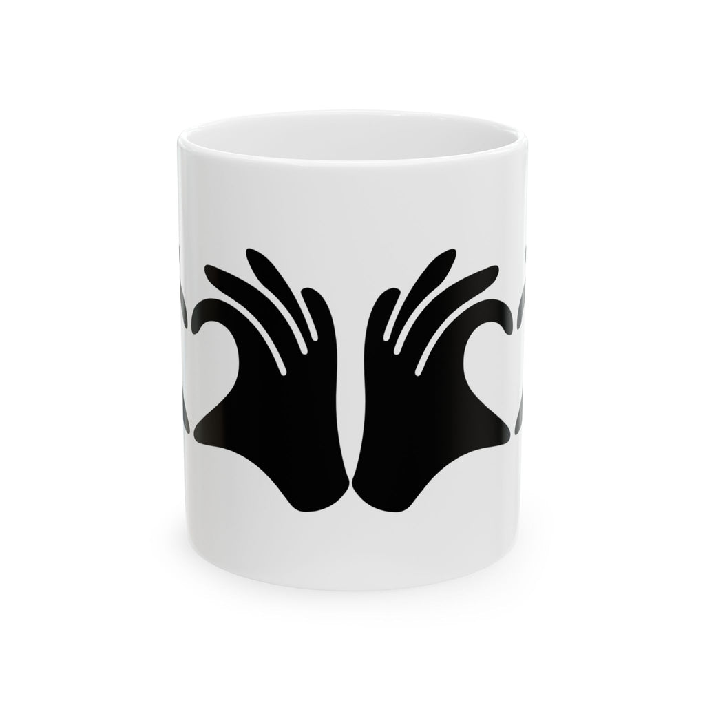 White mug with black hand design on a white background