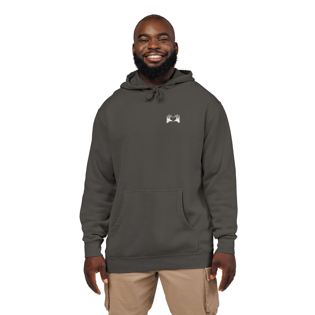 Man wearing a gray hoodie with a logo on a white background