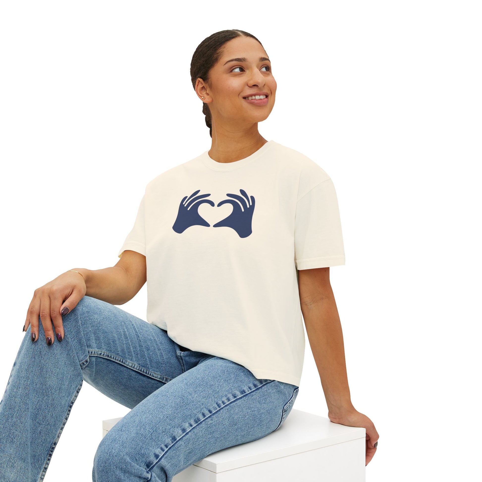 Woman wearing a white t-shirt with a blue graphic design on a white background