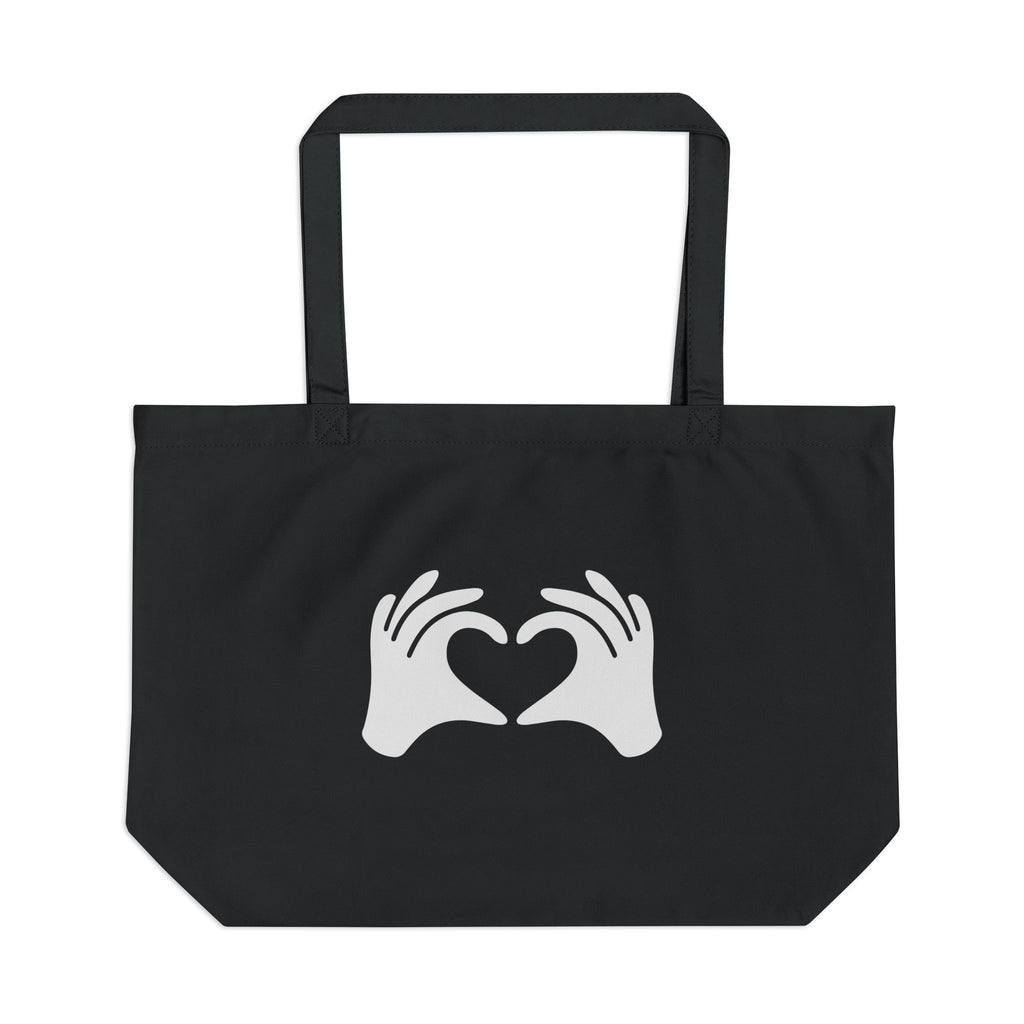 Black tote bag with white hands forming a heart design on a white background