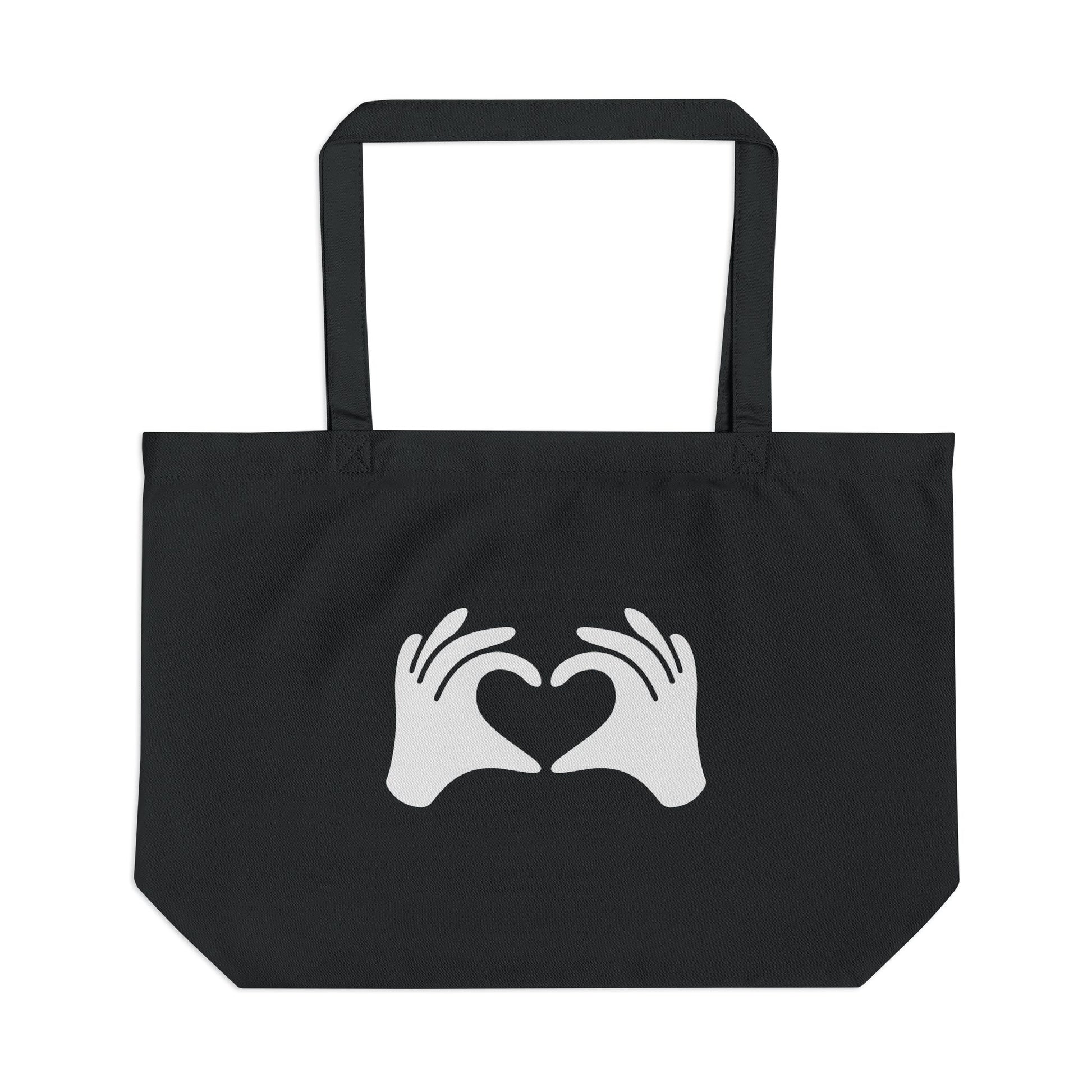 Black tote bag with white hands forming a heart design on a white background