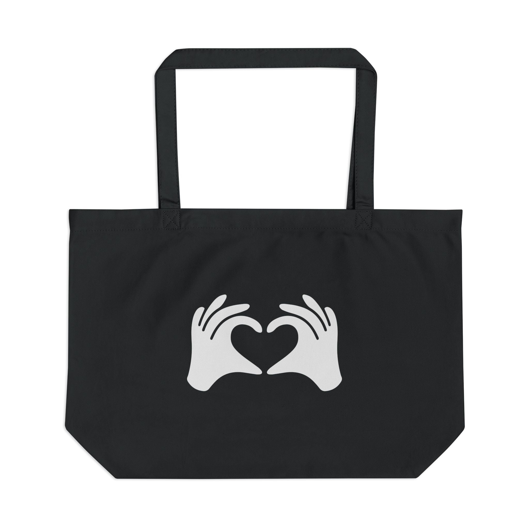 Black tote bag with white hands forming a heart design on a white background