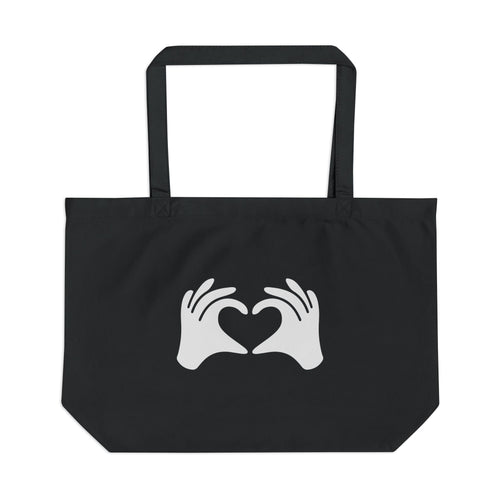 Black tote bag with white hands forming a heart design on a white background