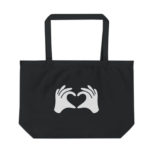 Black tote bag with white hands forming a heart design on a white background