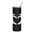 Black tumbler with white heart design and silver straw on a white background