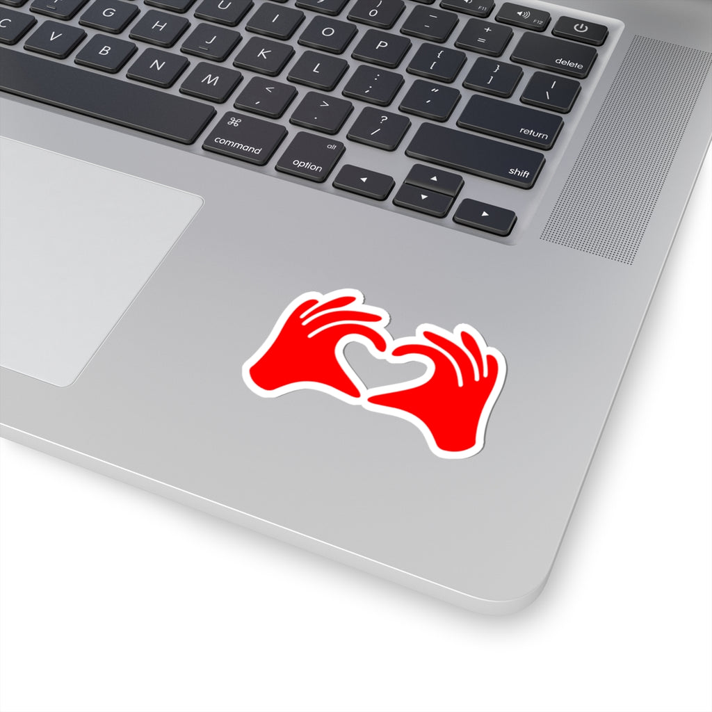 Red sticker with two hands forming a heart shape on a laptop